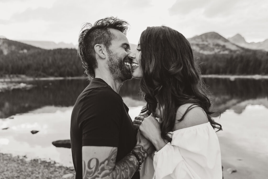 man and woman kissing at their engagement photoshoot
