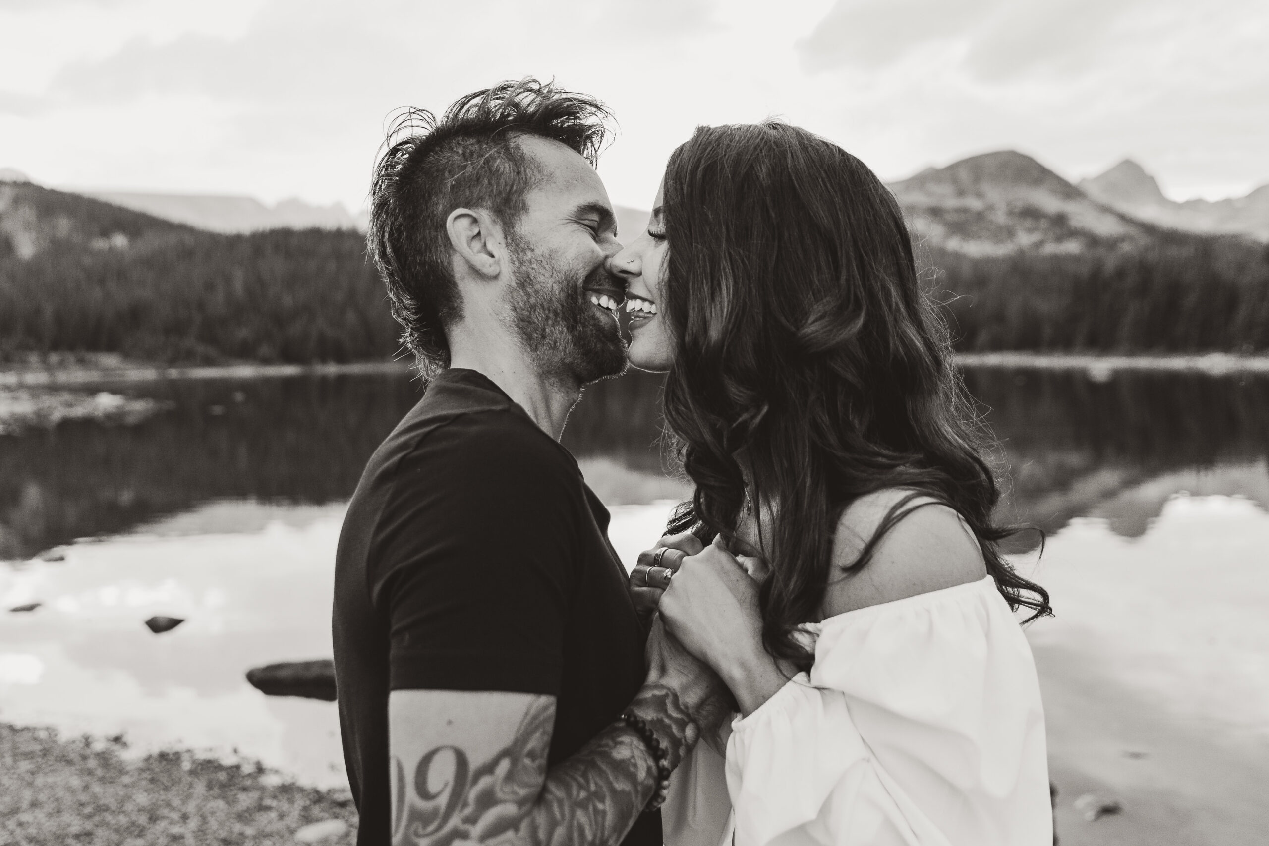 man and woman kissing at engagement photoshoot