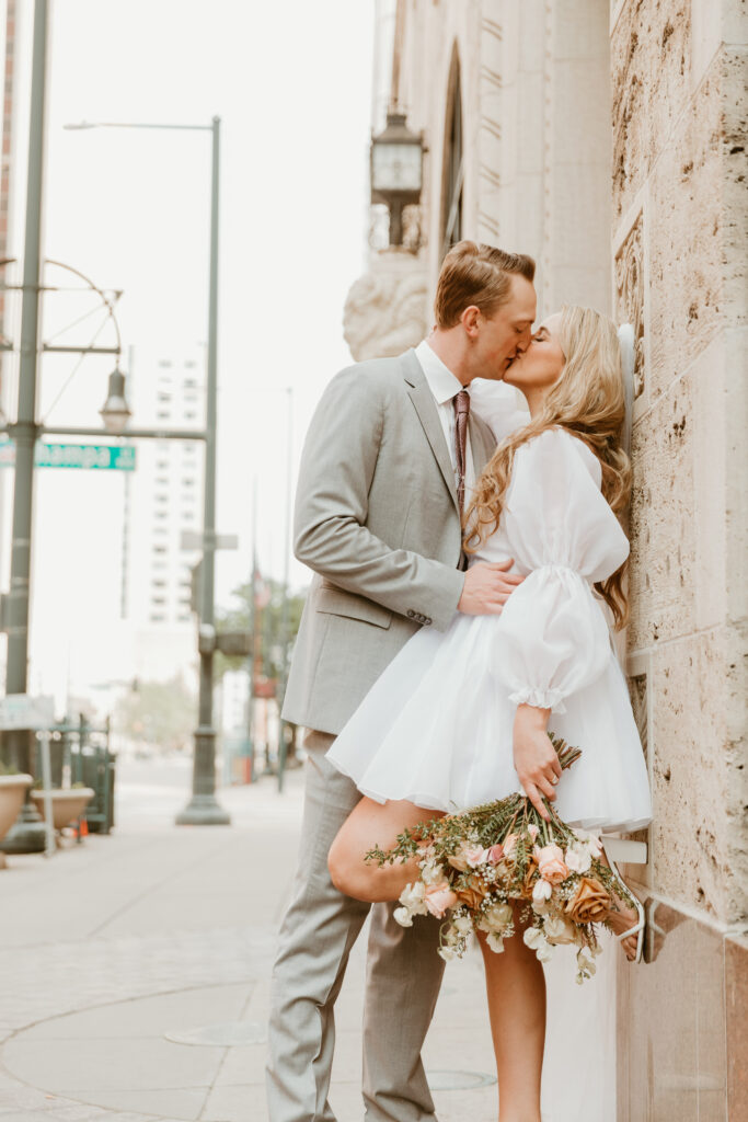 couple kissing downtown elopement